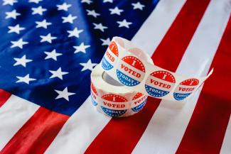 Roll of "I voted today" stickers sitting on American flag.