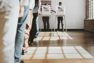 People standing in voting line.