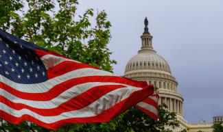 American flag with Capitol dome in the background